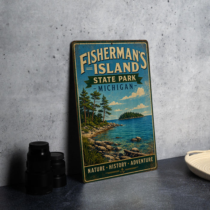 A vintage-style metal sign for Fisherman's Island State Park in Michigan, featuring a scenic landscape with a lake, trees, and mountains.