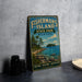A vintage-style metal sign for Fisherman's Island State Park in Michigan, featuring a scenic landscape with a lake, trees, and mountains.