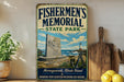 A vintage-style sign for Fishermen's Memorial State Park in Narragansett, Rhode Island, featuring a lighthouse, a monument, and a coastal scene.