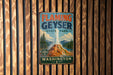 A vintage-style sign for Flaming Geyser State Park in Washington, featuring a scenic illustration of a geyser and mountains.
