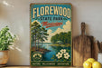 A vintage-style sign for Florewood State Park in Mississippi, featuring a scenic illustration of a lake surrounded by trees and a cabin.