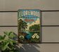 A vintage-style sign for Florewood State Park in Mississippi, featuring a scenic landscape with trees, a lake, and flowers.
