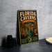 A vintage-style metal sign for Florida Caves State Park, featuring an illustration of the cave system and the text "FLORIDA CAVENS STATE PARK FLORIDA EXPLORE UNDERGROUND BEAUTY"