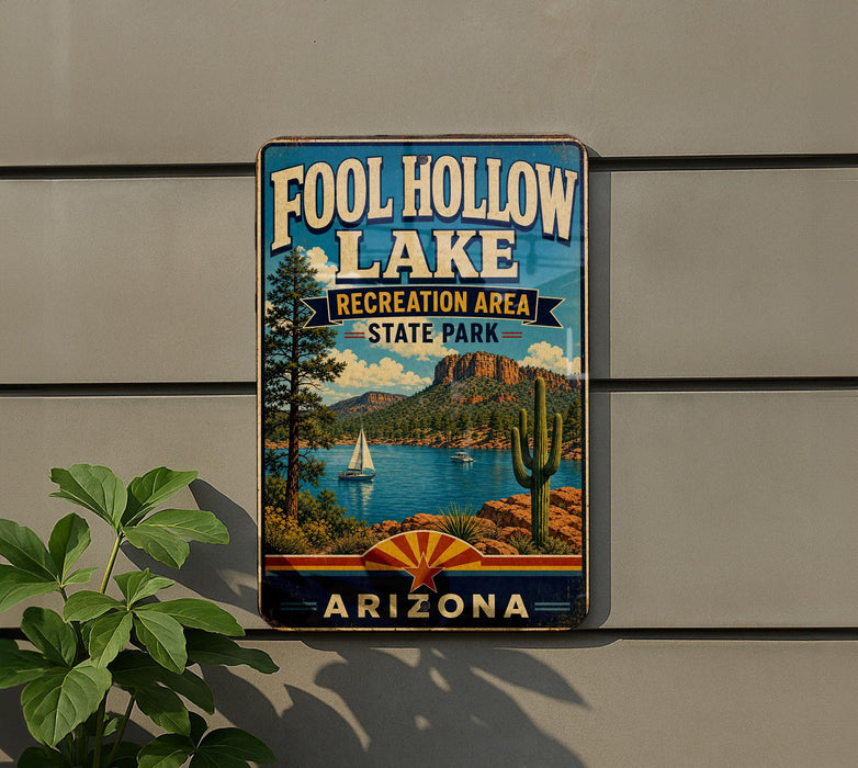 A vintage-style sign for Foolhole Lake, a recreation area in Arizona, featuring a scenic landscape with a lake, mountains, and a sailboat.