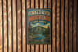 A vintage-style metal sign for the Forked River Mountain in New Jersey, featuring a scenic mountain landscape with pine trees and a river.