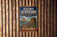 A vintage metal sign for Fort Atkinson State Historical Park in Nebraska, featuring an illustration of a historic fort and a river.