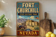A vintage-style metal sign for Fort Churchill State Historic Park in Nevada, featuring a desert landscape with a castle and mountains in the background.