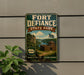 A vintage-style sign for Fort Defiance State Park, featuring a scenic image of the park and a wooden fort, mounted on a wall.