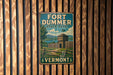 A vintage-style metal sign for Fort Ducker State Park in Vermont, featuring a scenic illustration of a fort and surrounding landscape.