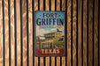 A vintage-style sign for Fort Griffin, a historic site in Texas, mounted on a wooden wall.
