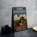 A vintage-style metal sign for Fort Hartsuff State Historical Park in Nebraska, featuring an illustration of a historical fort and cannon.