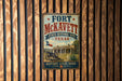 A vintage-style metal sign for Fort McKeett, a historic site in Texas, mounted on a wooden wall.