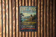 A vintage-style metal sign for Fort Ross State Historic Park in California, featuring a scenic illustration of a historic building and landscape.