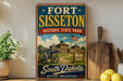A vintage-style sign for Fort Sisset, Historic State Park, featuring an illustration of a cannon and a building, with the text "Fort Sisset" and "South Dakota" prominently displayed.