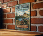 A vintage metal sign for Fort Snelling State Park in Minnesota, featuring a cannon and a scenic landscape.