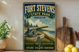 A vintage-style sign for Fort Stevens State Park in Oregon, featuring a cannon and a scenic landscape, is displayed on a shelf next to a wooden cutting board and some lemons.