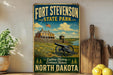A vintage-style sign for Fort Stevenson State Park in North Dakota, featuring a cannon and a house in the background.