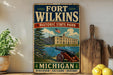 A vintage-style sign for Fort Wilkins Historic State Park in Michigan, featuring an illustration of a cannon and a building, with the text "Fort Wilkins" and "Michigan" prominently displayed.
