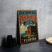 A vintage-style metal sign for Fort Zachary Taylor Historic State Park in Florida, featuring a colorful illustration of the fort and surrounding landscape.