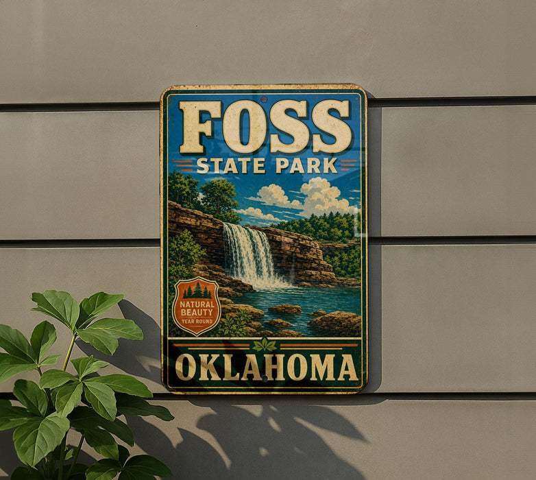A vintage-style sign for Foss State Park in Oklahoma, featuring a waterfall and lush greenery, is displayed on a wall.