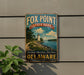A vintage metal sign for Fox Point State Park in Delaware, featuring a lighthouse and a scenic landscape.