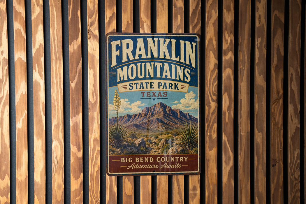 A vintage Franklin Mountains State Park sign is displayed on a wooden wall.