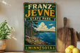 A vintage-style sign for Franz Jevne State Park in Minnesota, featuring a scenic landscape with a lake, mountains, and pine trees.