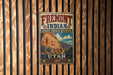 A vintage metal sign for Fremont Indian State Park & Museum, featuring an illustration of a rock formation with Native American art.