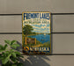 A vintage metal sign for Fremont Lakes State Recreation Area in Nebraska, featuring a scenic landscape with a lake, sailboat, and mountains.