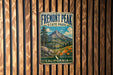 A vintage metal sign for Fremont Peak State Park in California, featuring a mountain landscape with pine trees and flowers.
