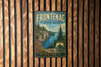 A vintage metal sign for Frontenac State Park in Minnesota, featuring a scenic landscape with a lake, mountains, and pine trees.