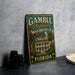 A vintage-style metal sign for Gamble Plantation Historic State Park in Florida, featuring an illustration of a historic plantation house surrounded by palm trees.