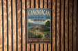 A vintage-style metal sign for the Gondagan State Historic Site, featuring an illustration of a Native American structure surrounded by a wooden fence and a scenic landscape.