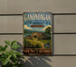 A vintage-style metal sign for the Ganondagan State Historic Site, featuring a depiction of a Native American structure surrounded by a wooden fence and a scenic landscape.