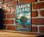A vintage-style sign for the Garden Island State Recreation Area in Minnesota, featuring a scenic image of a lake, island, and canoe.