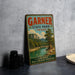 A vintage-style sign for Garner State Park in Texas, featuring a scenic landscape with a river and mountains.