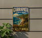 A vintage-style metal sign for Garrapata State Park in California, featuring a scenic coastal landscape with mountains, cliffs, and the ocean.