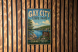 A vintage metal sign for Gay City State Park in Connecticut, featuring a scenic landscape with a lake and trees.