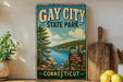 A vintage-style sign for Gay City State Park in Connecticut, featuring a scenic landscape with a lake and mountains.
