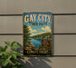 A vintage metal sign for Gay City State Park in Connecticut, featuring a scenic landscape with a lake and mountains.