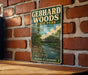 A vintage-style metal sign for Gebhard Woods State Park in Illinois, featuring a scenic illustration of a river and forest.