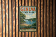 A vintage-style metal sign for Geneva State Park in Ohio, featuring a scenic image of a lake with a sailboat, surrounded by trees and mountains.