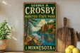 A vintage-style metal sign for George H. Crosby Manitou State Park in Minnesota, featuring a scenic landscape with a lake and mountains.