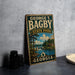 A vintage-style metal sign for George T. Bagby State Park in Georgia, featuring a scenic landscape with a river and trees.