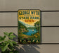 A vintage-style metal sign for George Wyth Memorial State Park in Iowa, featuring a scenic landscape with a lake, mountains, and a sailboat.