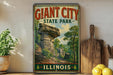 A vintage-style poster of Giant City State Park in Illinois, featuring a scenic landscape with a large rock formation and lush greenery.
