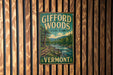 A vintage metal sign for Gifford Woods State Park in Vermont, featuring a scenic illustration of the park's natural surroundings.