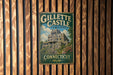 A vintage-style metal sign for Gillette Castle State Park in Connecticut, featuring an illustration of the castle and the words "Connecticut" below it.