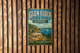 A vintage-style metal sign for Glen Elder State Park in Kansas, featuring a scenic landscape with a lake, mountains, and a sailboat.