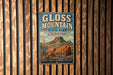 A vintage metal sign for Gloss Mountain State Park in Oklahoma, featuring a scenic illustration of the park's landscape.